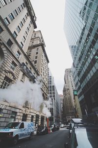 View of city street and buildings against clear sky