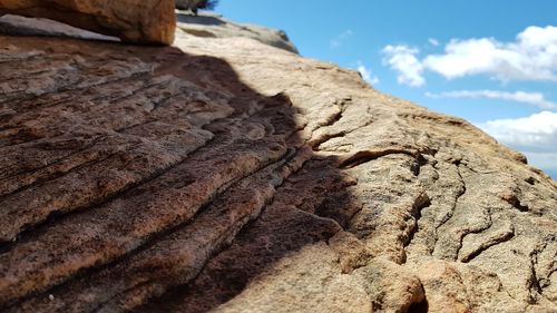 Low angle view of rock formation against sky
