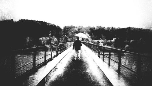 Full length rear view of woman standing in alley