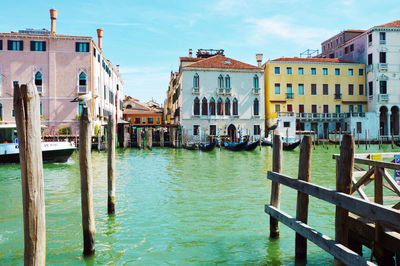 Canal amidst buildings against sky