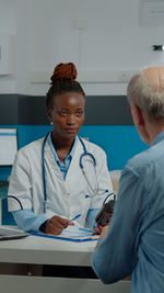 Doctor examining patient in clinic