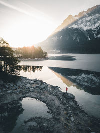 Scenic view of lake against sky during winter