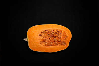 Close-up of orange slice against black background