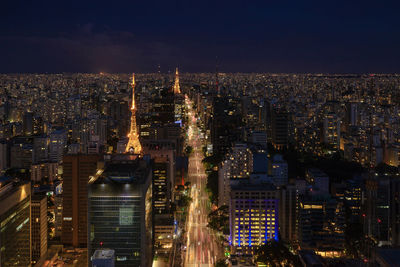 High angle view of illuminated cityscape against sky at night