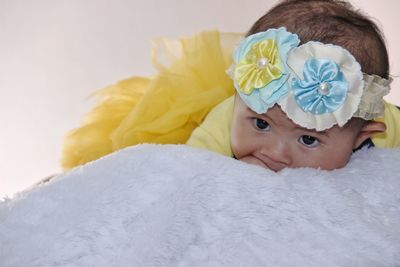 Cute baby girl lying on rug