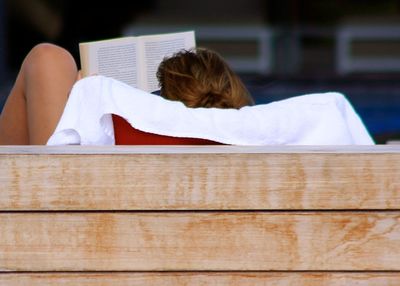 Rear view of woman reading book