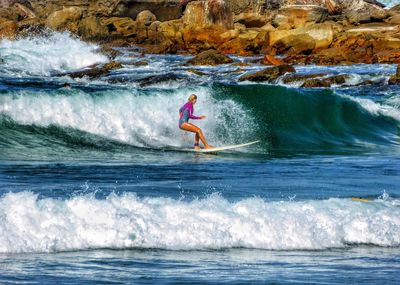 Woman surfing in sea