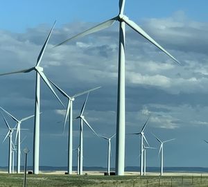 Windmill on field against sky