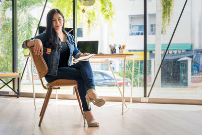 Portrait of businesswoman sitting on chair in office