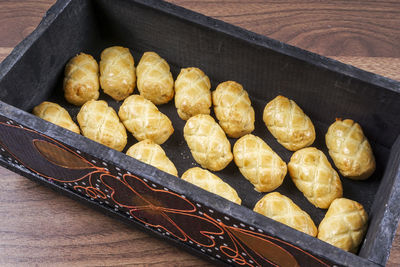 High angle view of potatoes in container on table