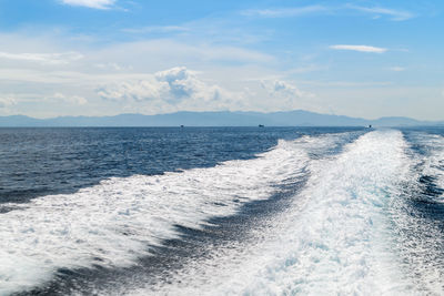 Trace tail of speed boat on water surface in the sea, travel summer concept.