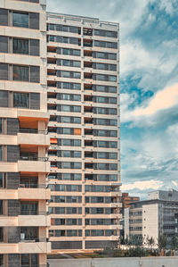 Low angle view of modern buildings in city against sky