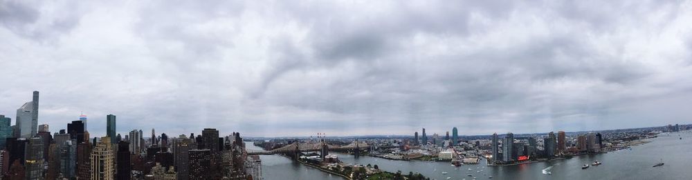 View of cityscape against cloudy sky