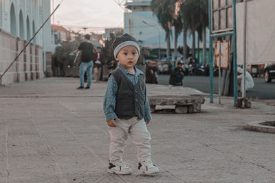 Full length of toddler walking on street in city