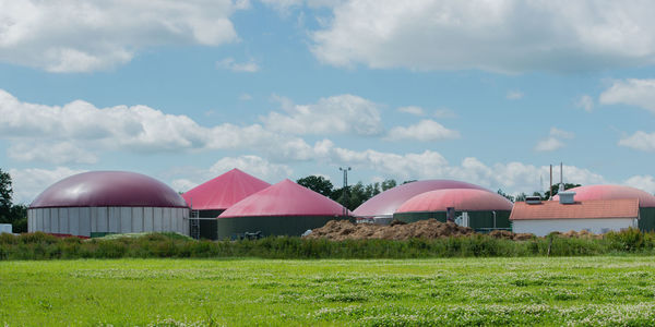 Built structure on field against sky