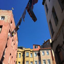 Low angle view of buildings against clear blue sky