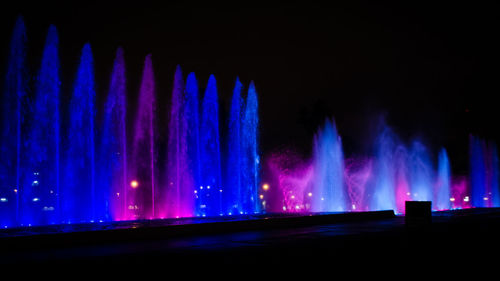 Illuminated lights against sky at night