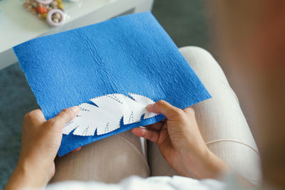 Midsection of woman reading book