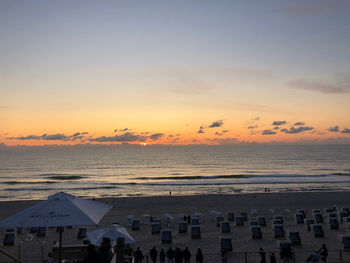 Scenic view of beach against sky during sunset