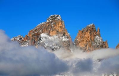 Low angle view of mountain against blue sky