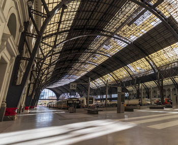 Trains on the platforms of a barcelona station with a fantastic roof