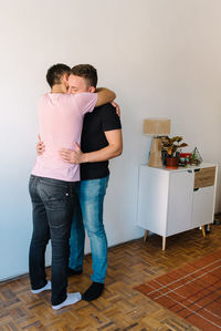 Two gay men holding each other.