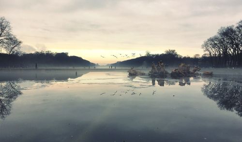 Scenic view of lake against sky during sunset