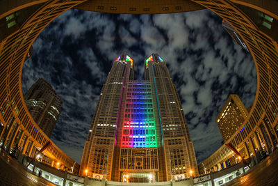 Low angle view of illuminated building against sky at night