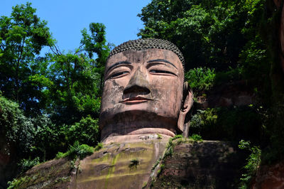 Low angle view of statue against trees