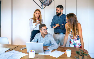 Business people in meeting evaluating trainee worker