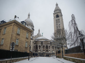 Historic building against sky during winter