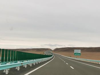 Empty road against sky