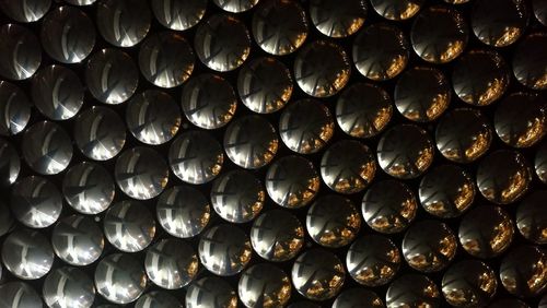 Full frame shot of patterned decorations with reflection