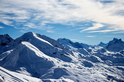 Scenic view of snow covered mountains against sky