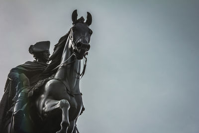 Low angle view of statue against sky