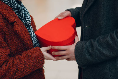 Midsection of woman holding hands