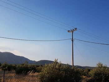 Low angle view of power lines against sky