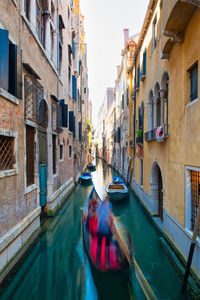 View of canal amidst buildings in city