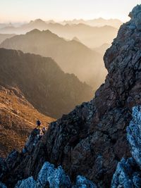 Person on mountain against sky