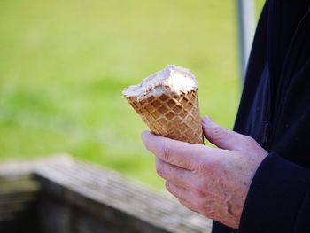 Close-up of hand holding ice cream