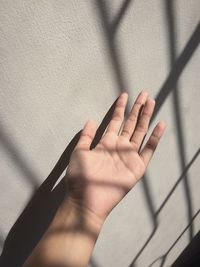 Shadow of person hand on wall