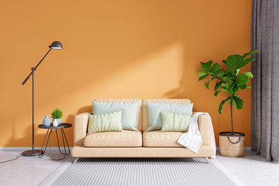 Potted plant on table against wall at home