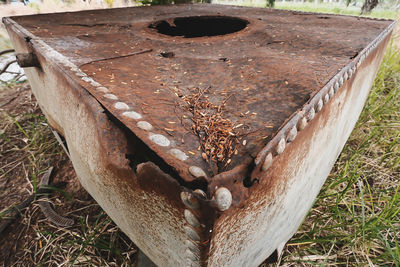 High angle view of rusty metal on field