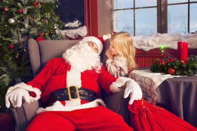 Girl looking at sleeping santa claus