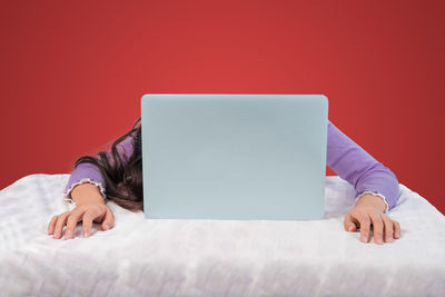 Midsection of man using mobile phone on table