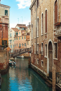 Canal passing through buildings in city