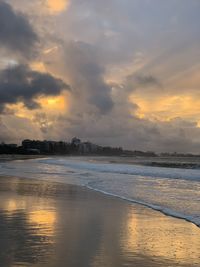 Scenic view of beach against sky during sunset