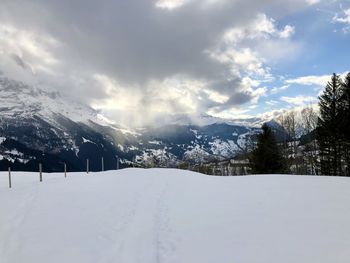 Snow covered landscape against sky