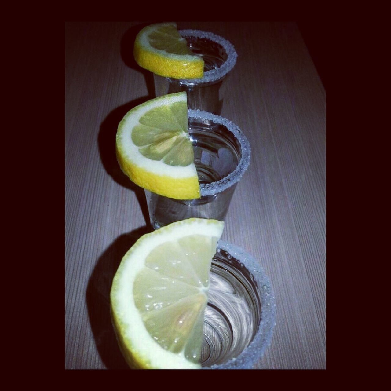 food and drink, freshness, indoors, food, healthy eating, still life, table, drink, yellow, refreshment, close-up, lemon, fruit, bowl, slice, ready-to-eat, high angle view, healthy lifestyle, drinking glass, plate