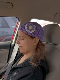 Woman wearing knit hat in car
